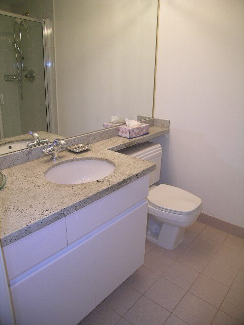Bathroom with granite countertops and white cabinets. - 1701 - 867 Hamilton Street, Vancouver Downtown