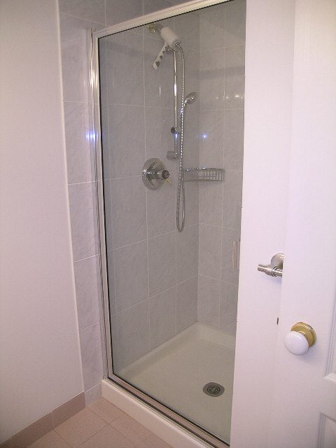 Bathroom with glass shower, modern fixtures, and white walls. - 1701 - 867 Hamilton Street, Vancouver Downtown
