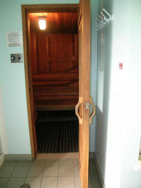Furnished entryway leading to a wooden staircase, light blue walls, and a small control panel. - 1701 - 867 Hamilton Street, Vancouver Downtown
