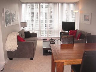 Furnished living room with city view and modern furniture. - 2901-1438 Richards Street, Vancouver Downtown