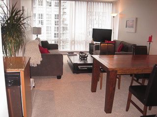 Furnished living room with hardwood floors, city view, and modern furniture. - 2901-1438 Richards Street, Vancouver Downtown