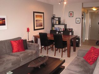 Furnished living room with cozy sofa, red cushions, and modern decor. - 2901-1438 Richards Street, Vancouver Downtown