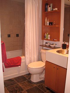 Furnished bathroom with a bathtub, toilet, and countertop. - 2901-1438 Richards Street, Vancouver Downtown