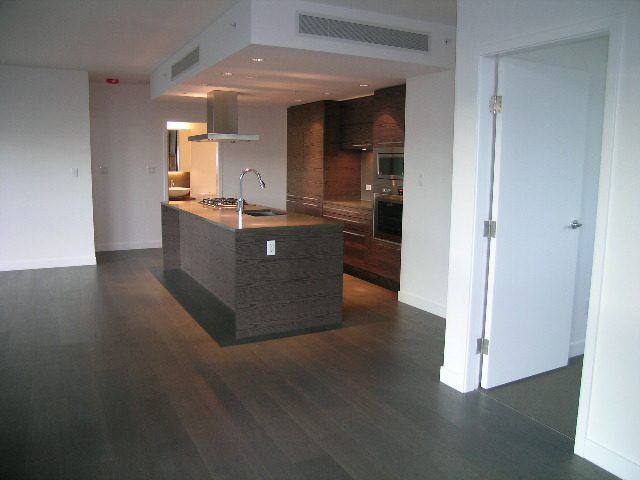 Bright kitchen with dark wood countertops and hardwood floors, modern design. - 602 - 5782 Berton Avenue, Vancouver West Side
