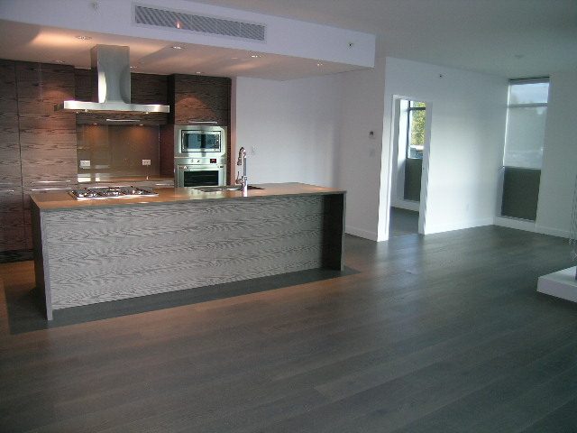 Bright kitchen with modern island, hardwood floors, and stainless steel appliances. - 602 - 5782 Berton Avenue, Vancouver West Side
