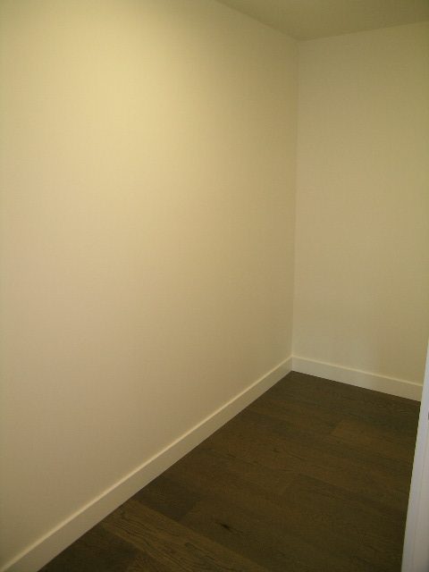 Bright living room with hardwood floors and white walls. - 602 - 5782 Berton Avenue, Vancouver West Side