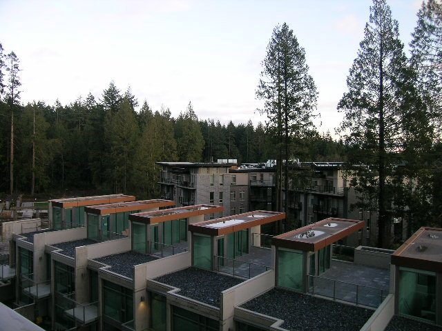Spacious living area with modern furnishings and forest views. - 602 - 5782 Berton Avenue, Vancouver West Side
