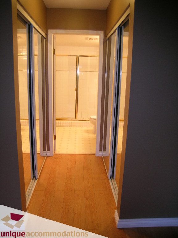 Bathroom with wooden floors and glass shower doors. - 208 - 128 West 8th Street, North Vancouver