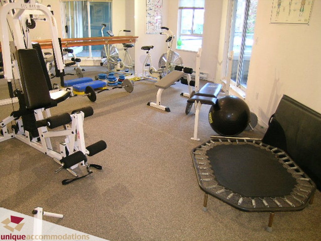 Fitness room with exercise equipment, trampoline, and weights. - 208 - 128 West 8th Street, North Vancouver