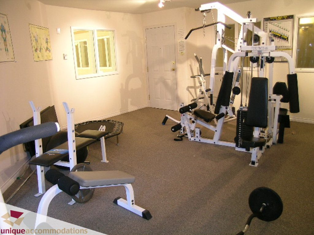 Bright home gym with weight bench and multi-gym equipment. - 208 - 128 West 8th Street, North Vancouver