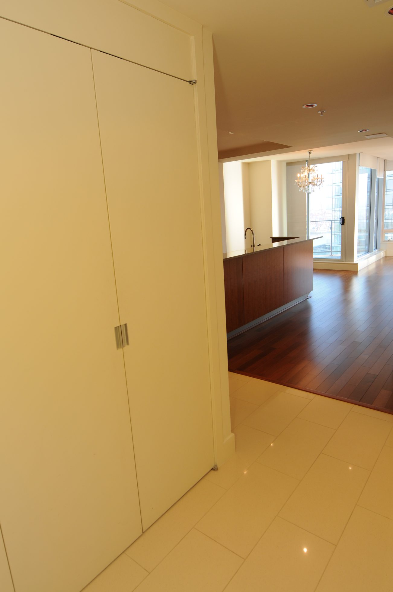Bright kitchen with hardwood floors and a city view through large windows. - 2304 - 1077 West Cordova St, Vancouver Downtown