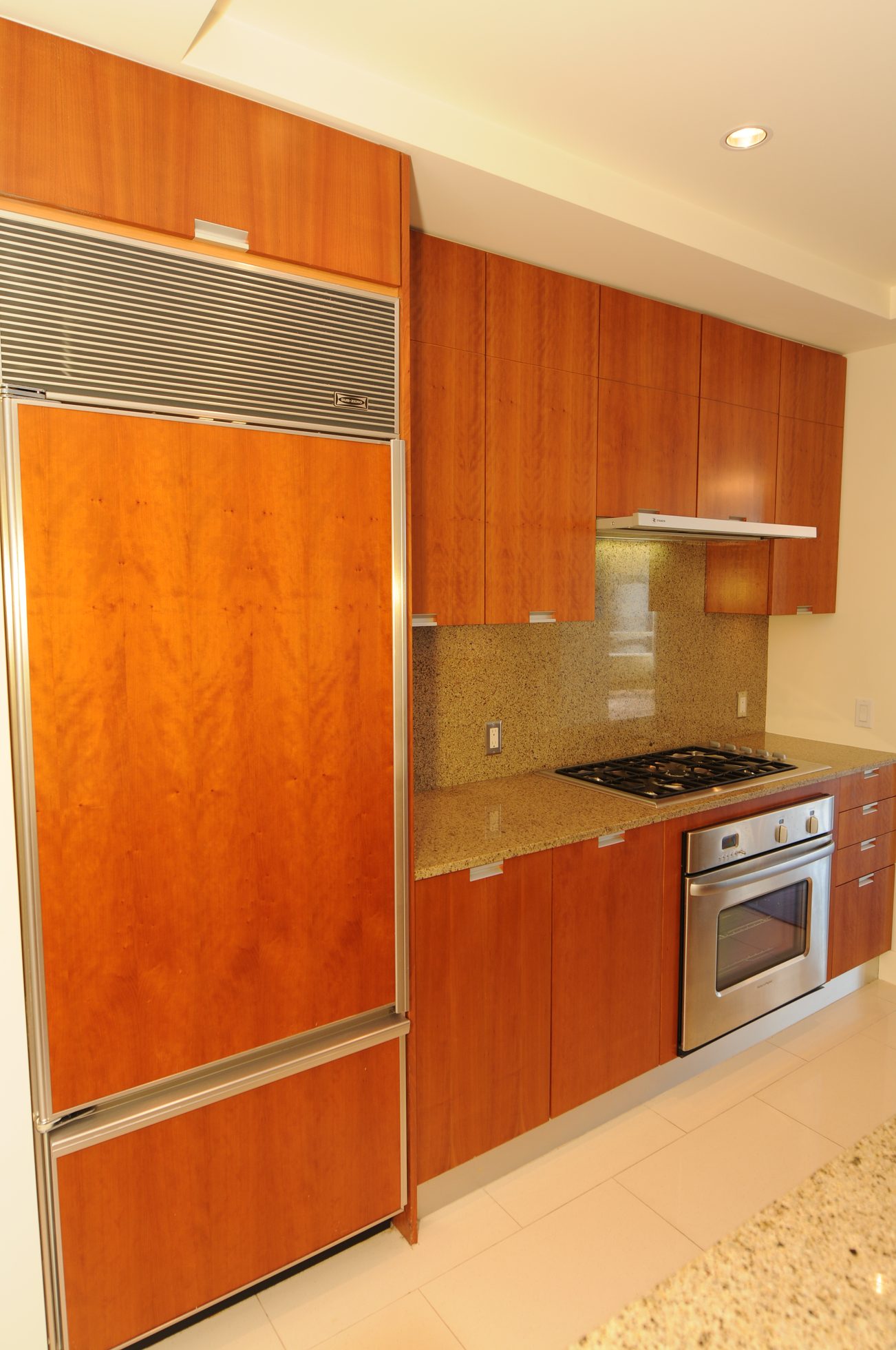 Bright kitchen with wood cabinets, granite countertops, and stainless steel appliances. - 2304 - 1077 West Cordova St, Vancouver Downtown