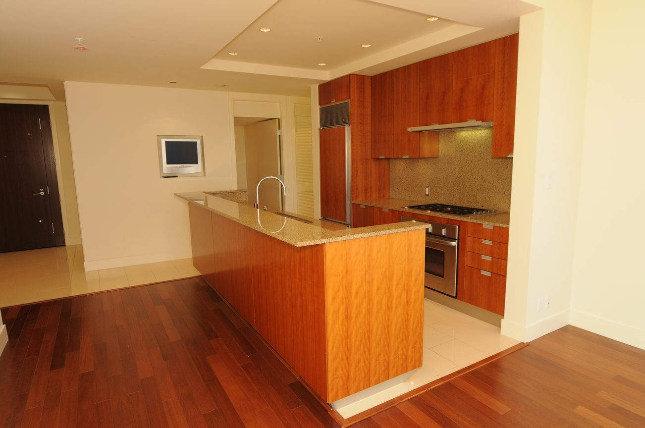 Bright kitchen with granite countertops, hardwood floors, and modern cabinetry. - 2304 - 1077 West Cordova St, Vancouver Downtown