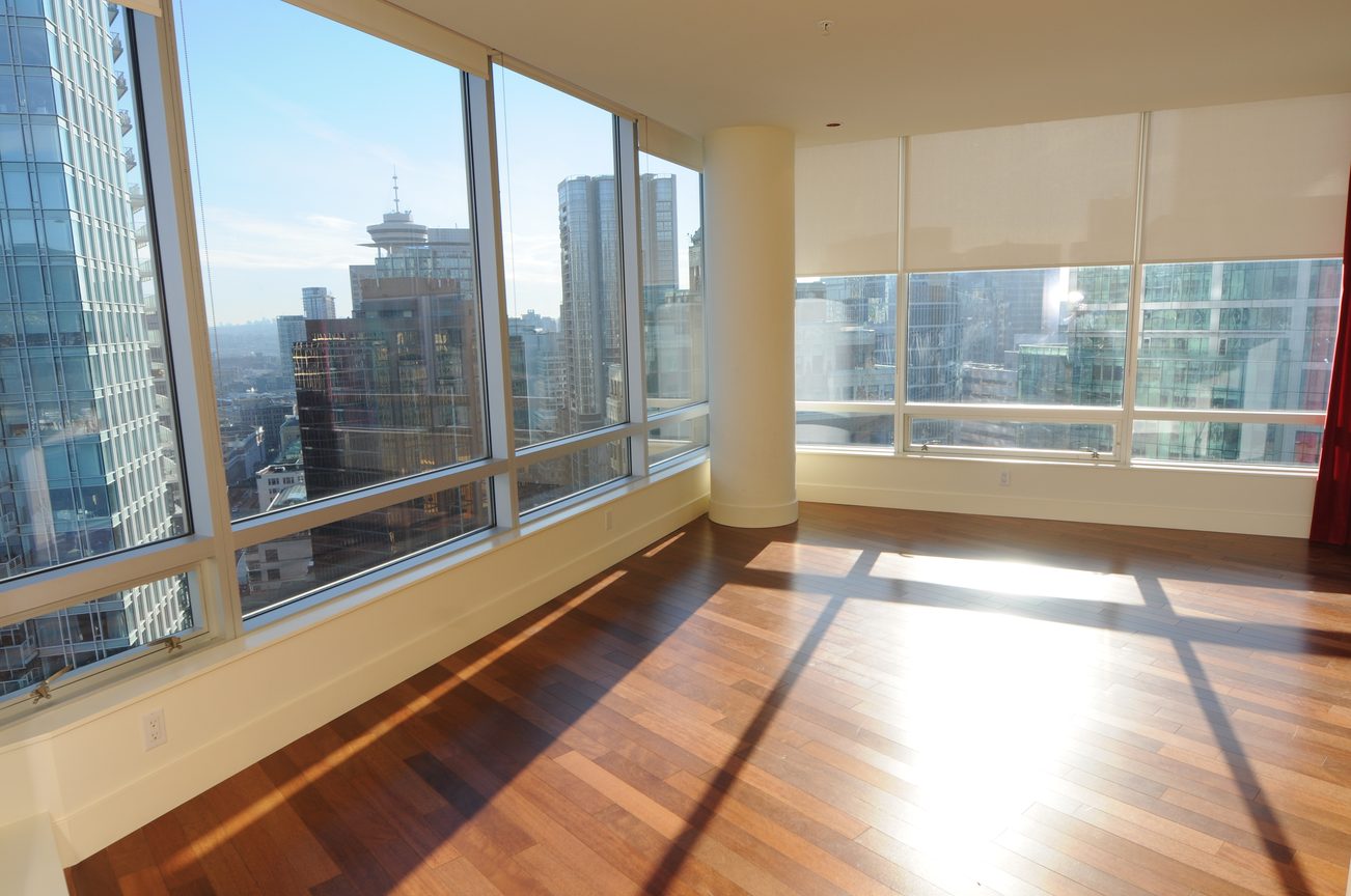 Bright living room with hardwood floors and a stunning city view. - 2304 - 1077 West Cordova St, Vancouver Downtown