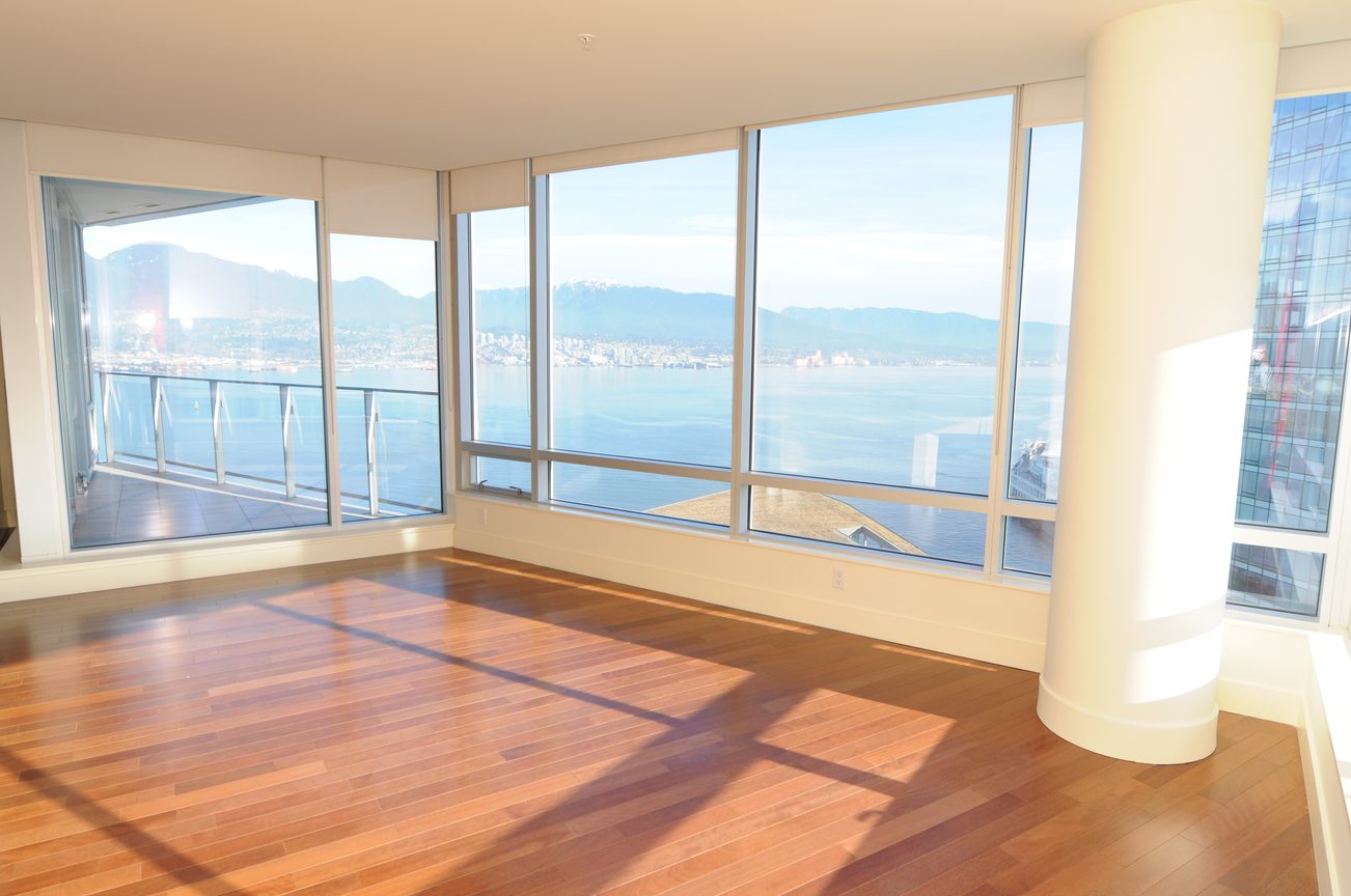 Bright living room with hardwood floors and a stunning city view. - 2304 - 1077 West Cordova St, Vancouver Downtown