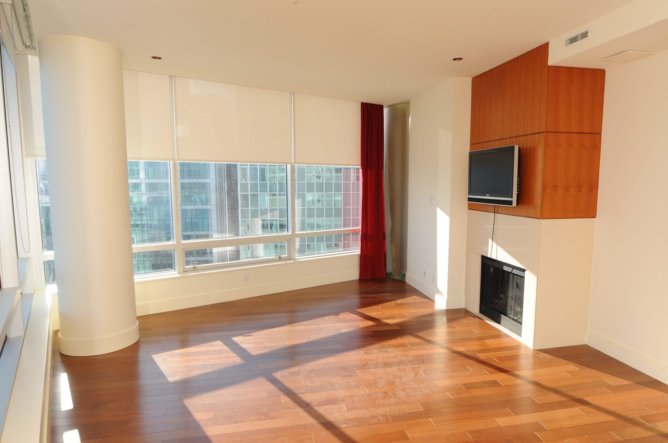 Bright living room with hardwood floors, city view, and modern decor. - 2304 - 1077 West Cordova St, Vancouver Downtown