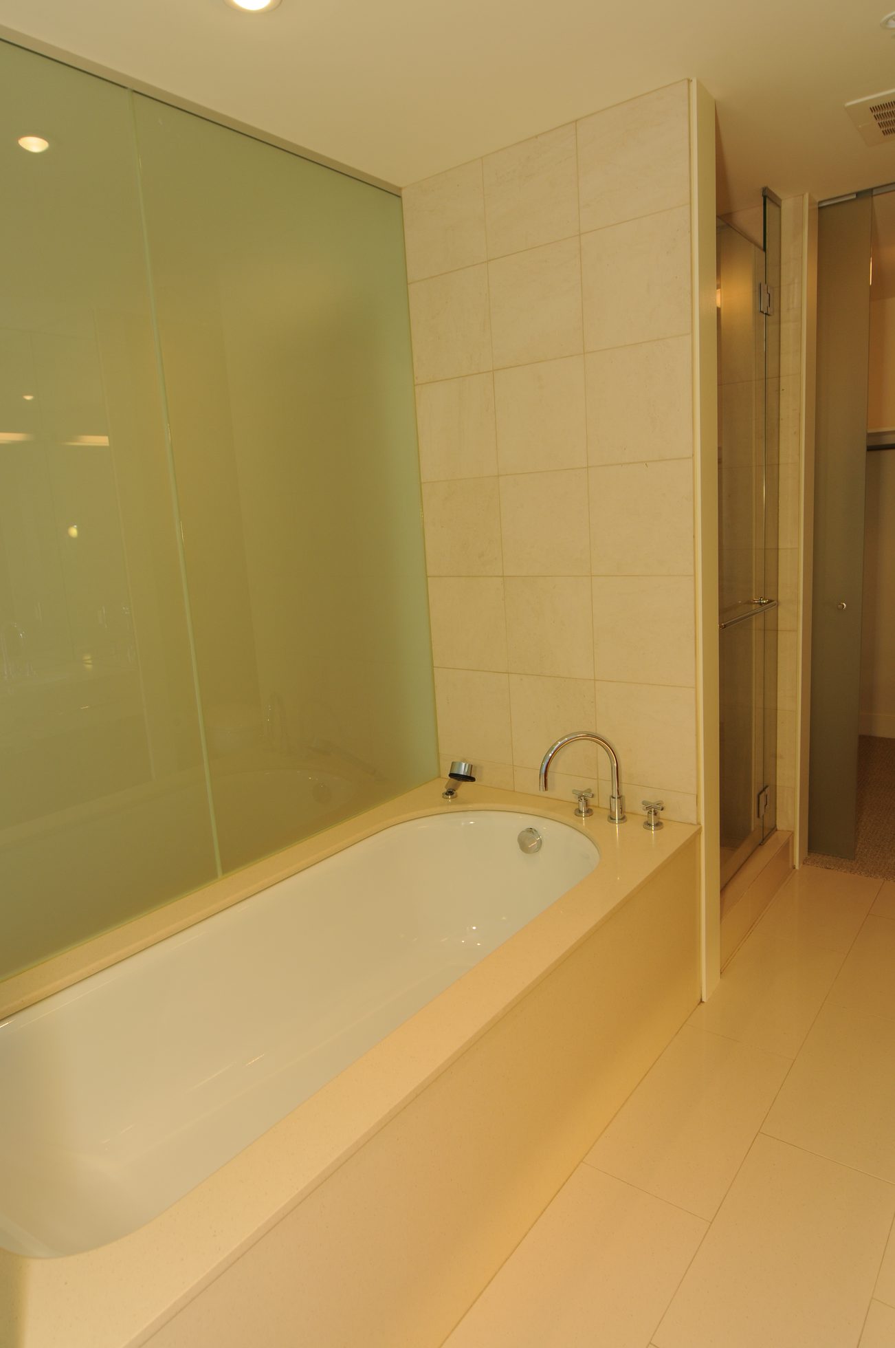 Furnished bathroom with a corner bathtub and glass shower enclosure. - 2304 - 1077 West Cordova St, Vancouver Downtown