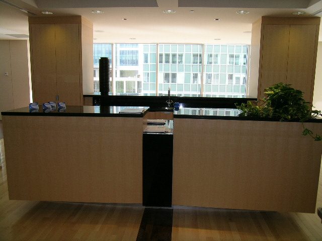 Furnished kitchen with sleek black countertops and city view. - 2304 - 1077 West Cordova St, Vancouver Downtown