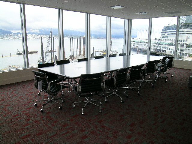 Large conference room with panoramic city view, modern furniture, and red carpet. - 2304 - 1077 West Cordova St, Vancouver Downtown