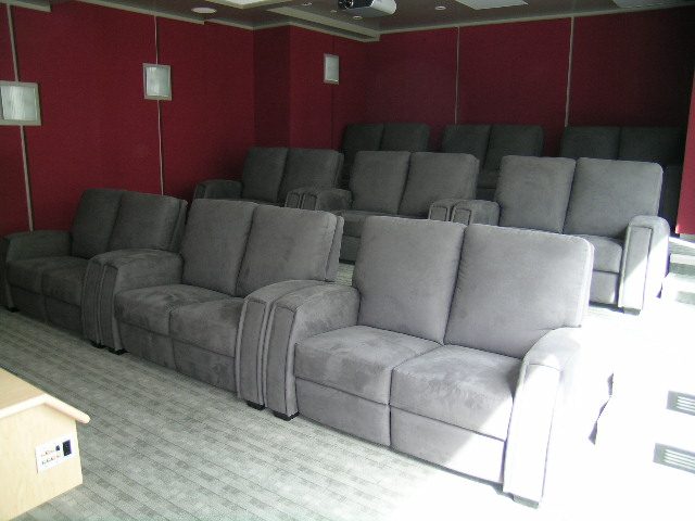 Entertainment room with reclining seats and red walls. - 2304 - 1077 West Cordova St, Vancouver Downtown