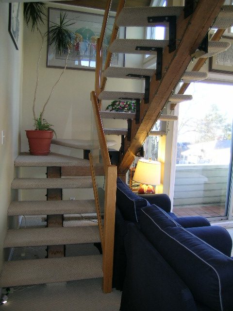 Furnished living room with a staircase leading to upper level, modern decor, and natural light. - 1628 Stephens Street, Vancouver West Side