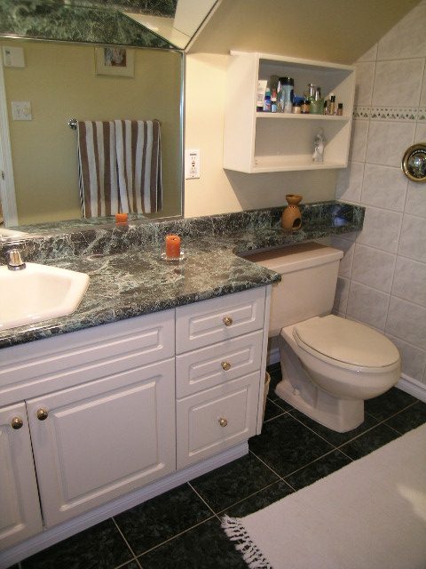 Bathroom with marble countertop and white cabinets. - 1628 Stephens Street, Vancouver West Side