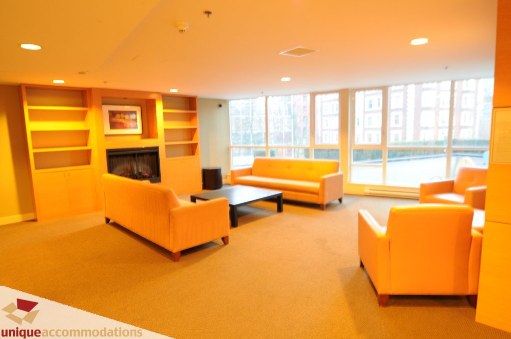 Furnished living room with orange accent furniture and large windows. - 1802 - 1189 Melville Street, Vancouver Downtown
