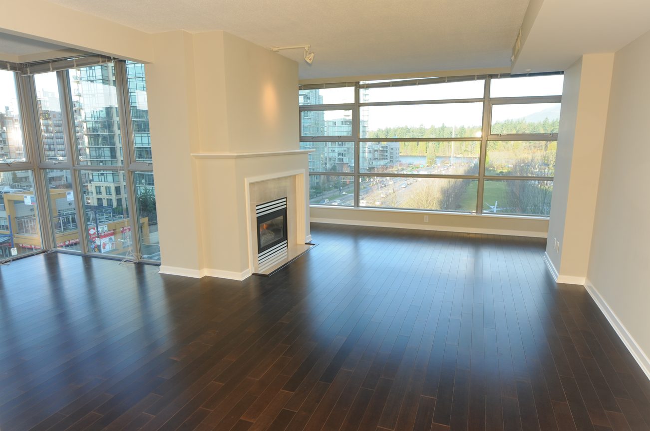Bright living room with hardwood floors, city view, and fireplace. - 604 - 1790 Bayshore Drive, Vancouver Downtown