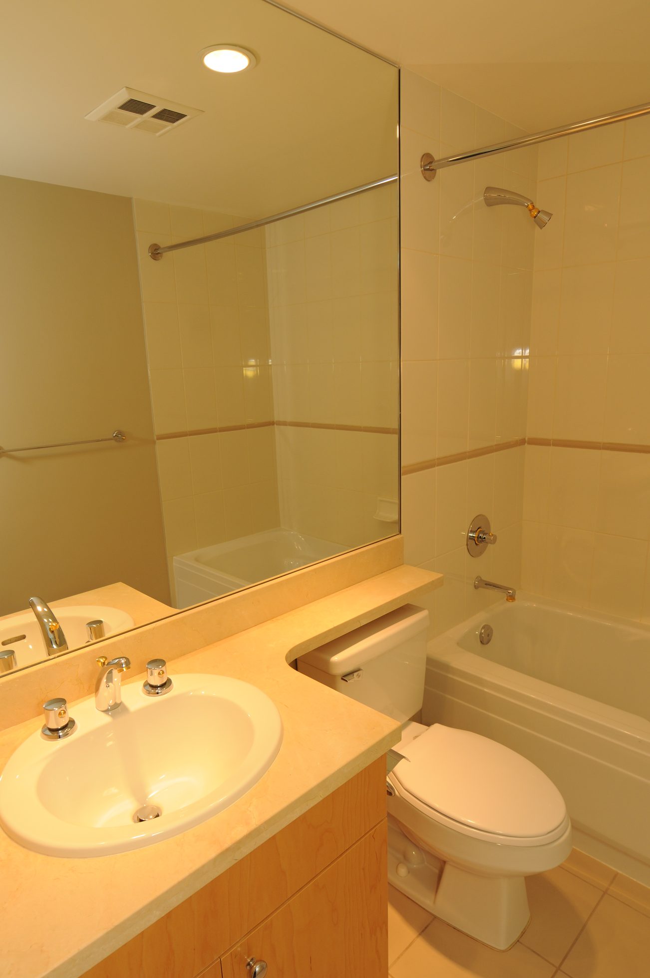 Bright bathroom with dual sinks, granite countertop, and a shower/tub combo. - 604 - 1790 Bayshore Drive, Vancouver Downtown