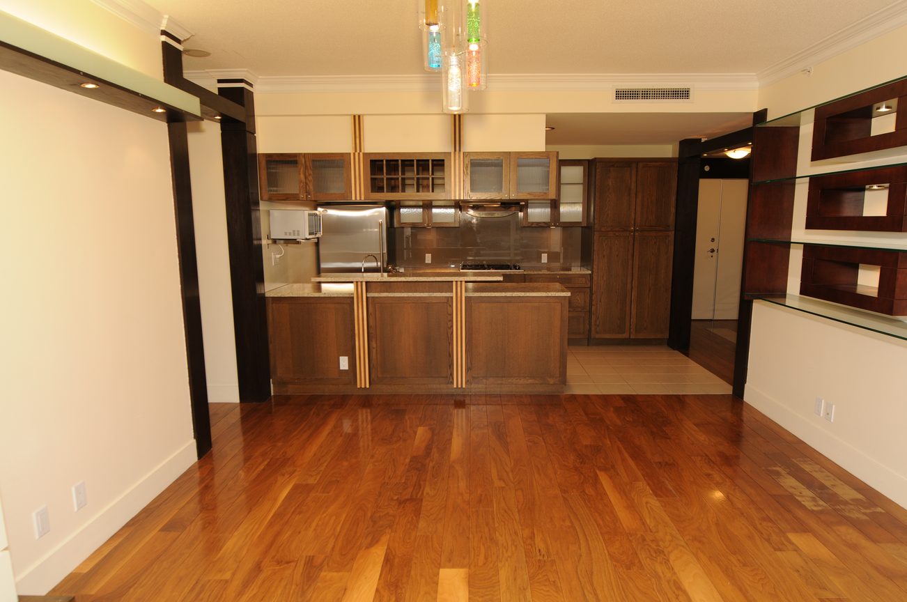 Bright kitchen with dark wood cabinets, granite countertops, and hardwood floors. - 2603 - 1483 Homer Street, Vancouver Downtown