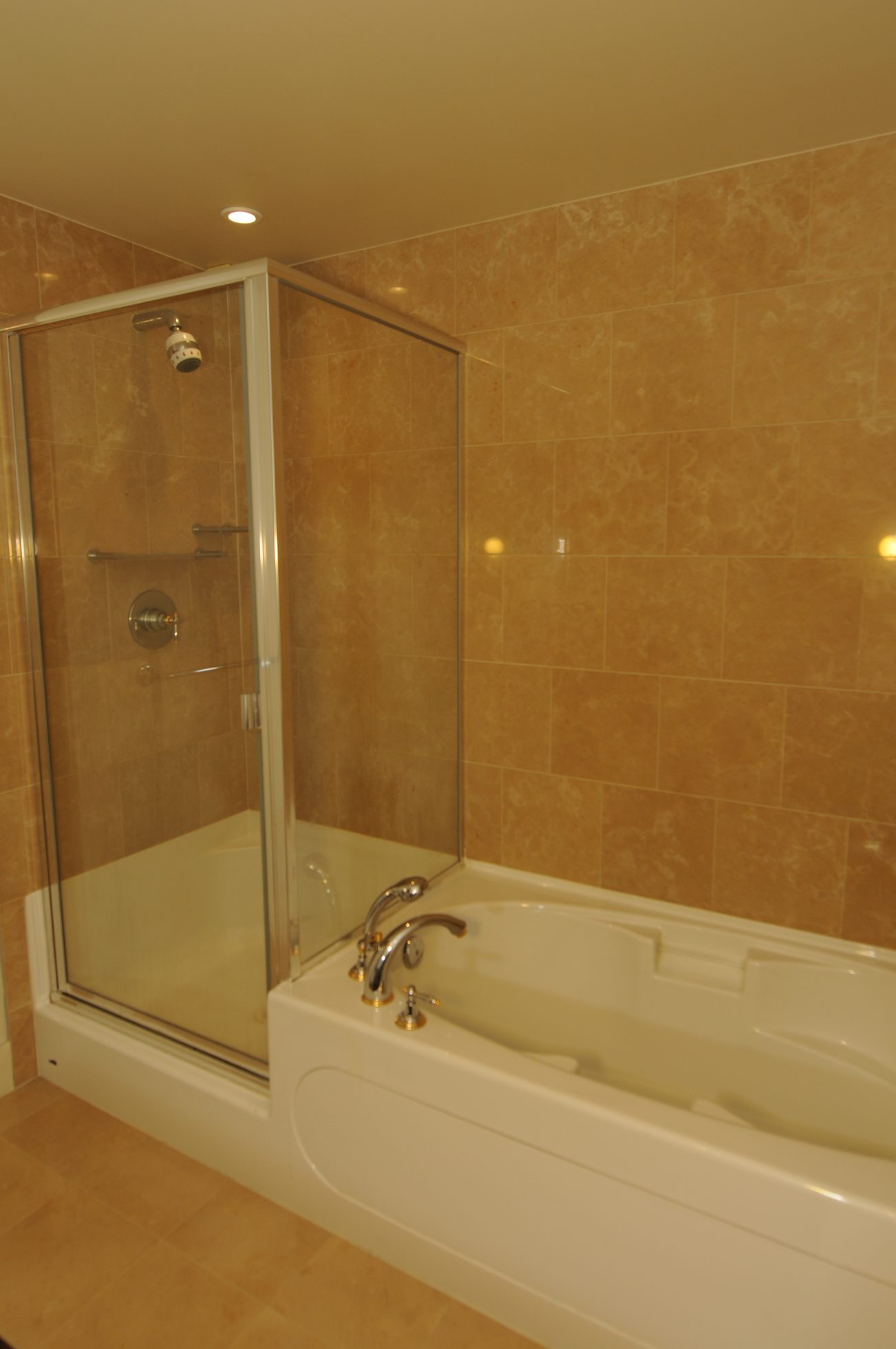 Bathroom with walk-in shower and bathtub, beige tile walls. - 2603 - 1483 Homer Street, Vancouver Downtown