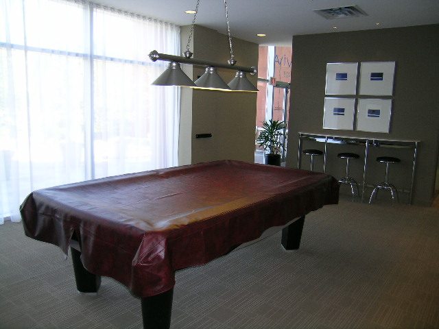 Bright dining area with leather table and modern lighting, city view. - 2603 - 1483 Homer Street, Vancouver Downtown