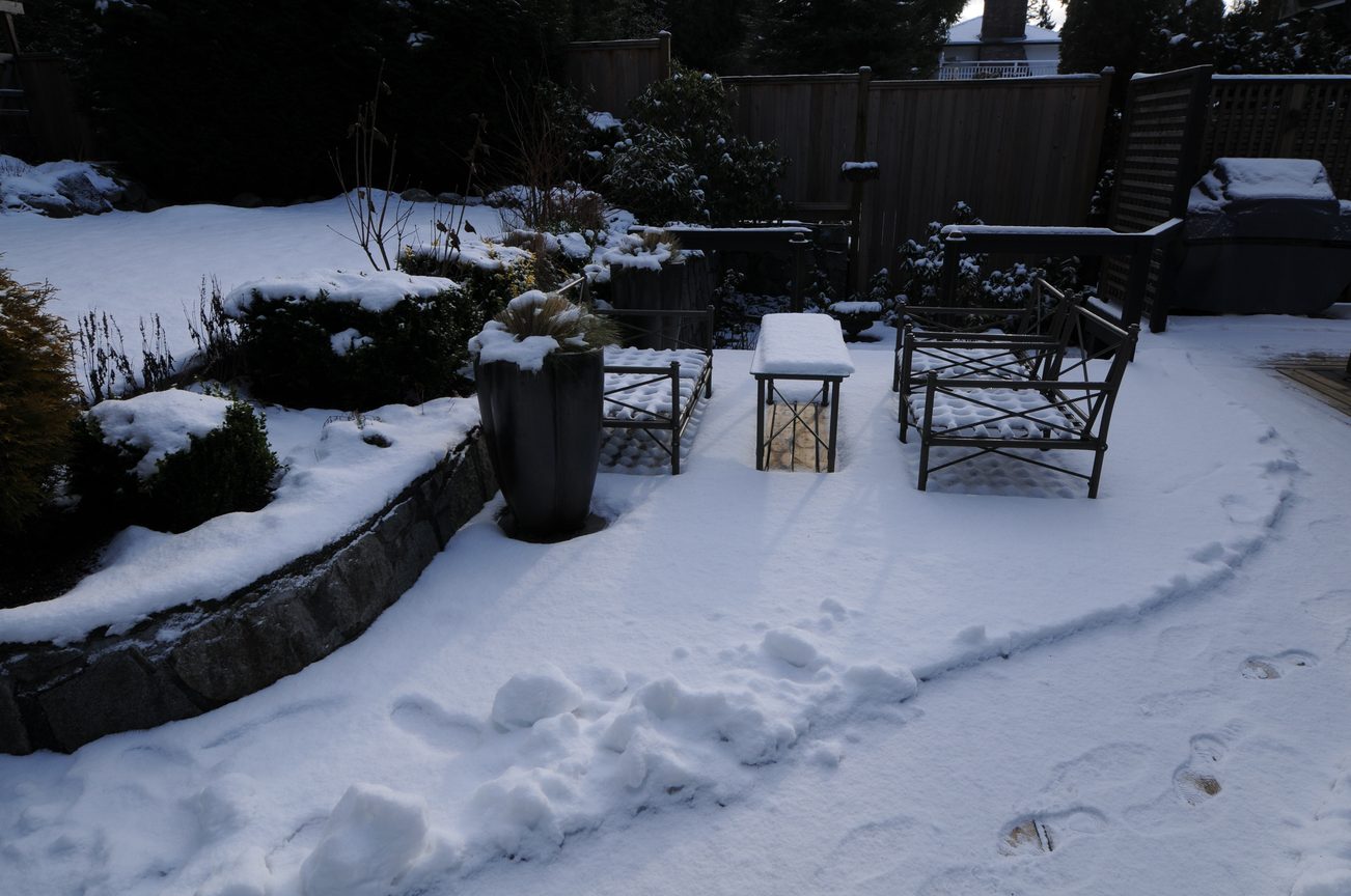 Furnished patio with snow-covered furniture and plants. - 4196 Norwood Avenue, North Vancouver