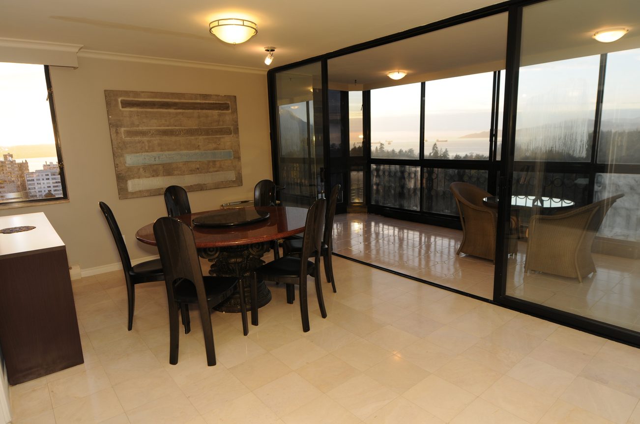 Furnished dining area with city view and large windows. - 1501 - 845 Chilco Street, Vancouver Downtown
