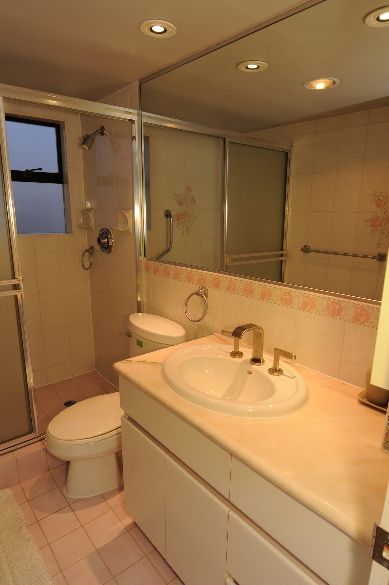 Bathroom with white vanity, gold faucet, and sliding glass shower. - 1501 - 845 Chilco Street, Vancouver Downtown