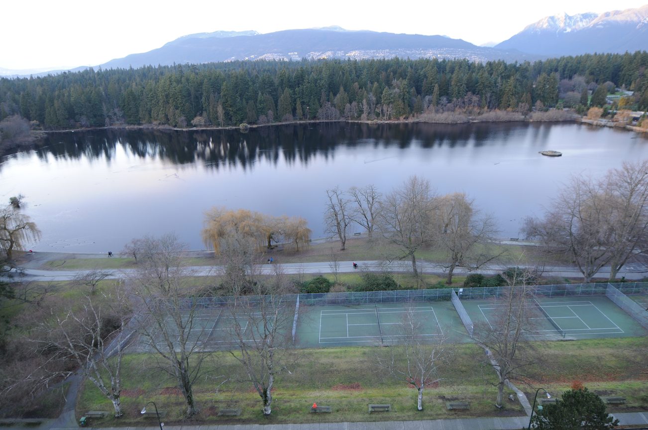 Furnished living room with a view of a serene lake and mountains. - 1501 - 845 Chilco Street, Vancouver Downtown