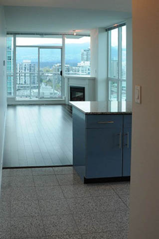 Bright kitchen with blue cabinets, hardwood floors, and a city view. - 1808 - 188 East Esplanade, North Vancouver