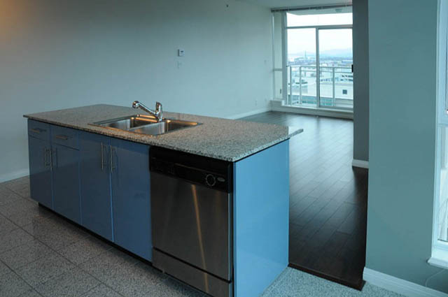 Bright kitchen with granite countertops, stainless steel appliances, and hardwood floors. - 1808 - 188 East Esplanade, North Vancouver