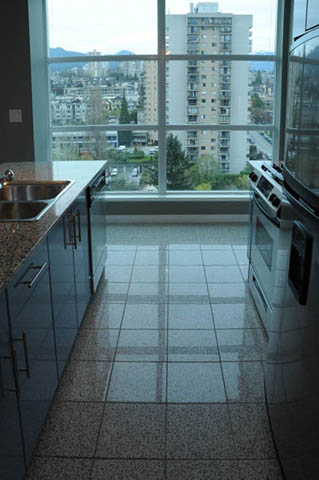Bright kitchen with granite countertops, city view, and modern tile flooring. - 1808 - 188 East Esplanade, North Vancouver