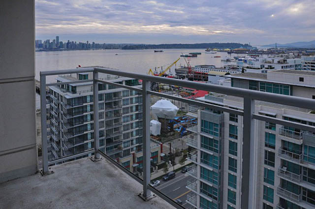 Balcony with city view and waterfront, overlooking construction site and mountains. - 1808 - 188 East Esplanade, North Vancouver