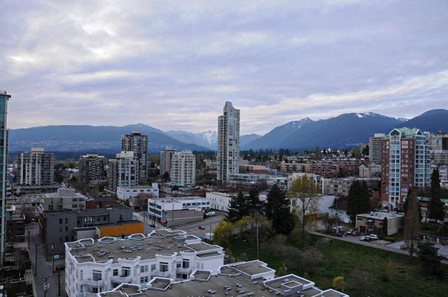 Bright living room with city view and modern furnishings. - 1808 - 188 East Esplanade, North Vancouver