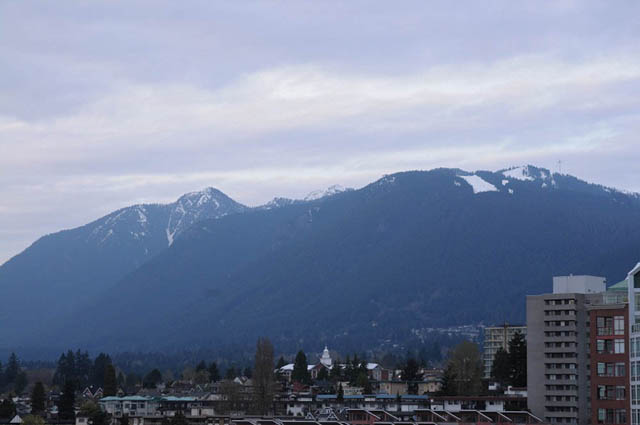 Bright living room with stunning city view and mountain backdrop. - 1808 - 188 East Esplanade, North Vancouver