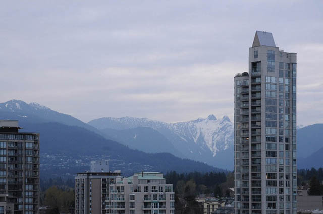 Spacious living room with stunning mountain views and modern balcony. - 1808 - 188 East Esplanade, North Vancouver