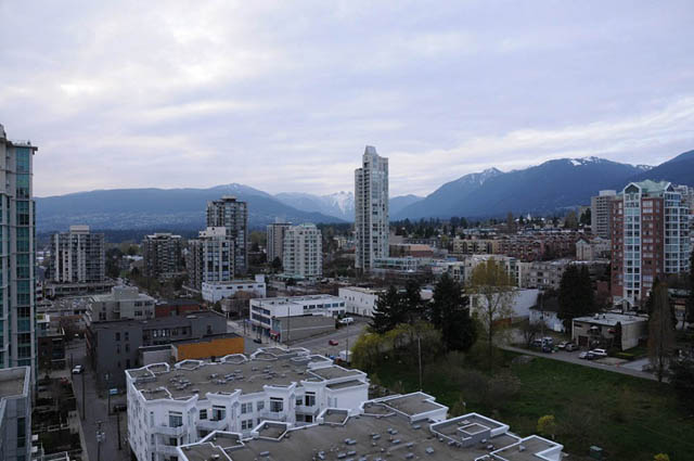 Bright living room with city view and modern furnishings. - 1808 - 188 East Esplanade, North Vancouver
