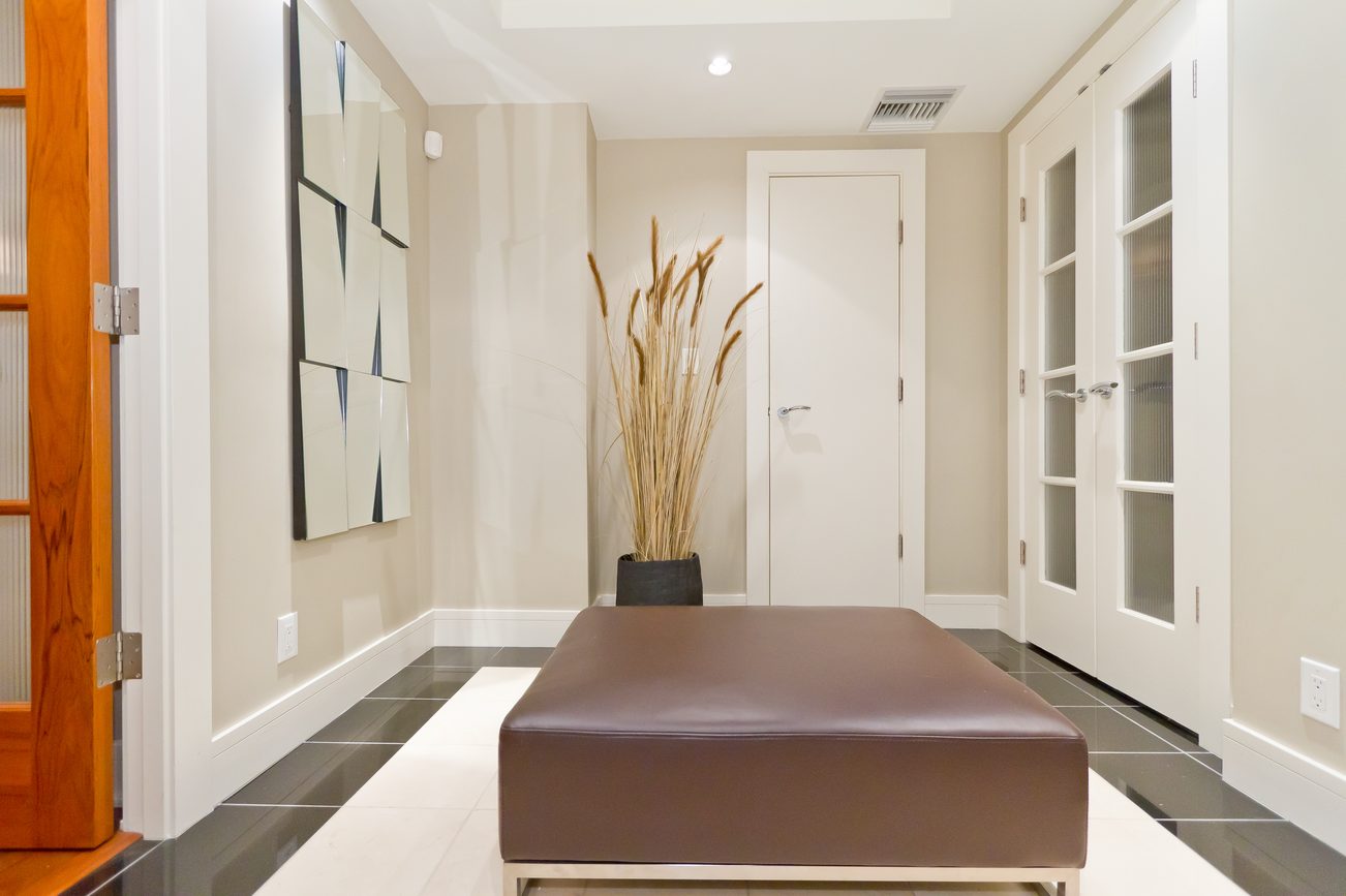 Foyer with modern art, sleek bench, and minimalist decor. - 302 - 628 Kinghorne Mews, Vancouver Downtown