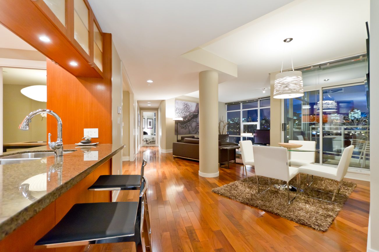 Bright kitchen with granite countertops, hardwood floors, and a city view. - 302 - 628 Kinghorne Mews, Vancouver Downtown