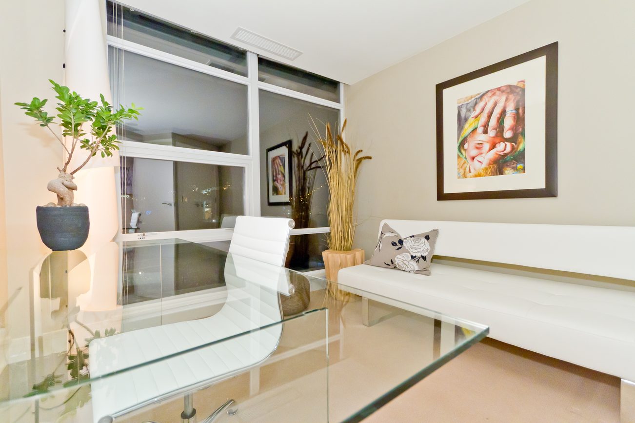 Furnished dining area with glass table, white chairs, and wall art. - 302 - 628 Kinghorne Mews, Vancouver Downtown