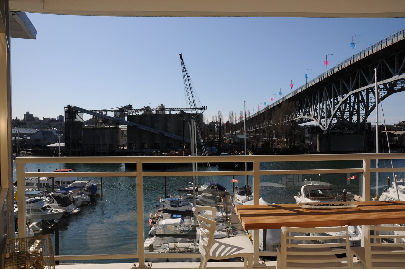 Furnished balcony with city view and marina boats, bridge in the distance. - 302 - 628 Kinghorne Mews, Vancouver Downtown