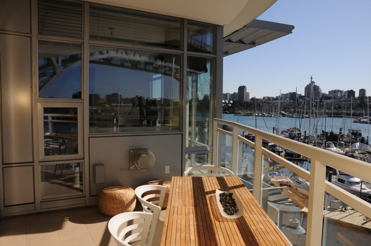 Furnished balcony with city view and wooden seating. - 302 - 628 Kinghorne Mews, Vancouver Downtown