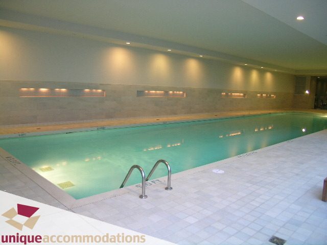 Spacious indoor pool with tiled flooring and modern lighting. - 302 - 628 Kinghorne Mews, Vancouver Downtown